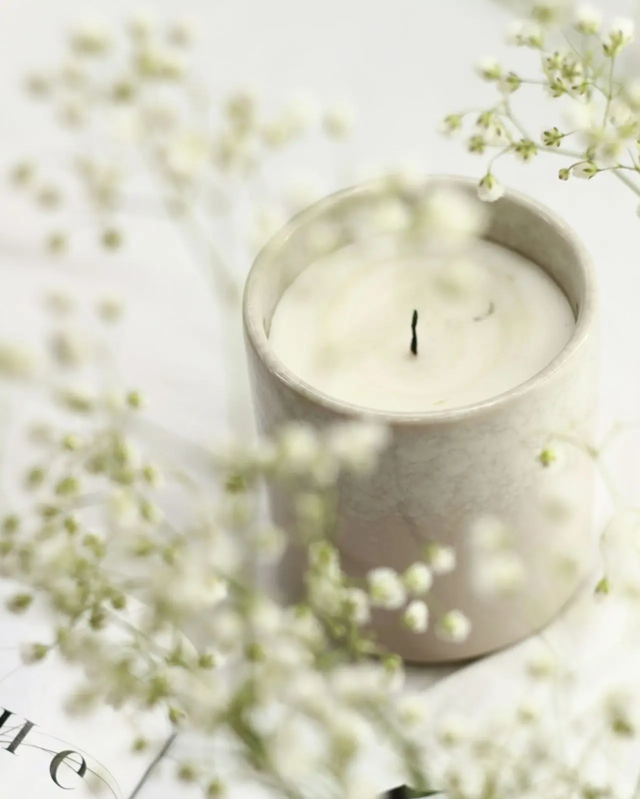 white candle in clear glass holder