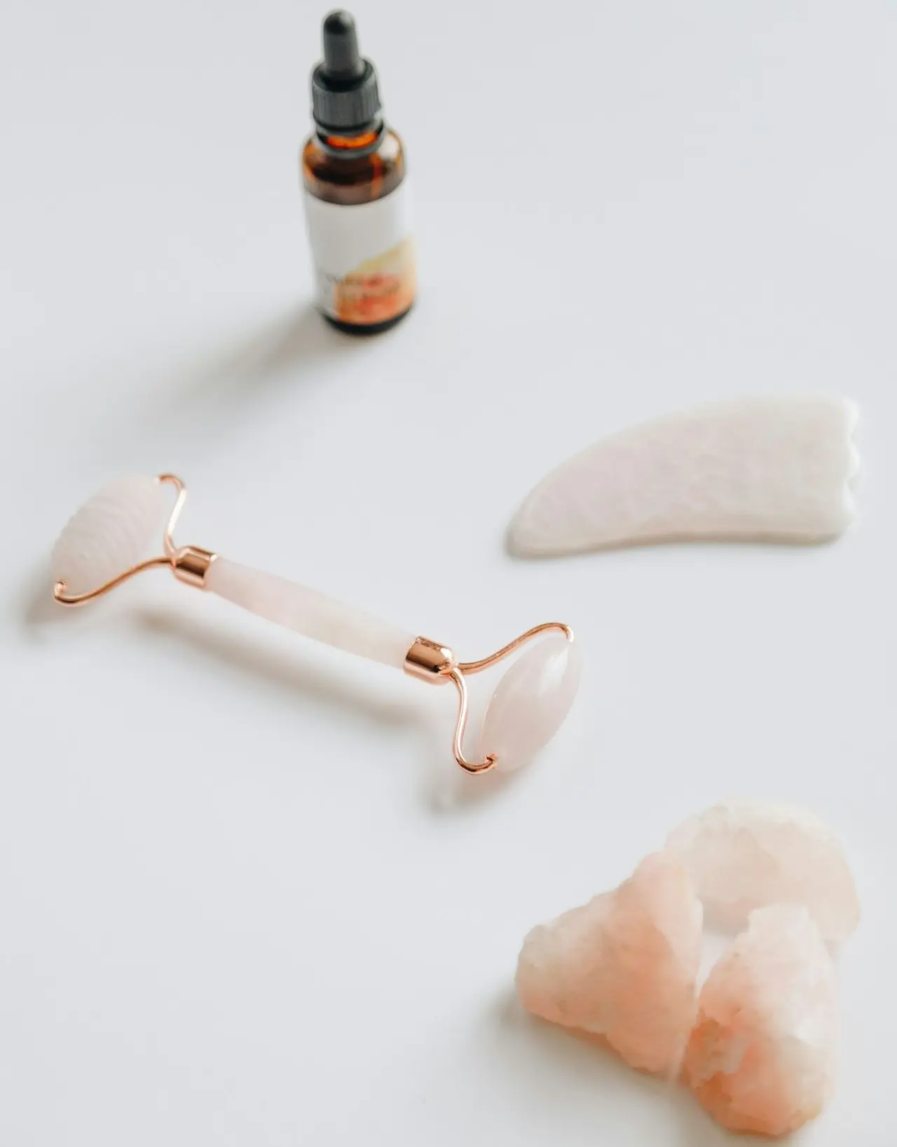 white and black glass bottle beside white heart shaped ornament